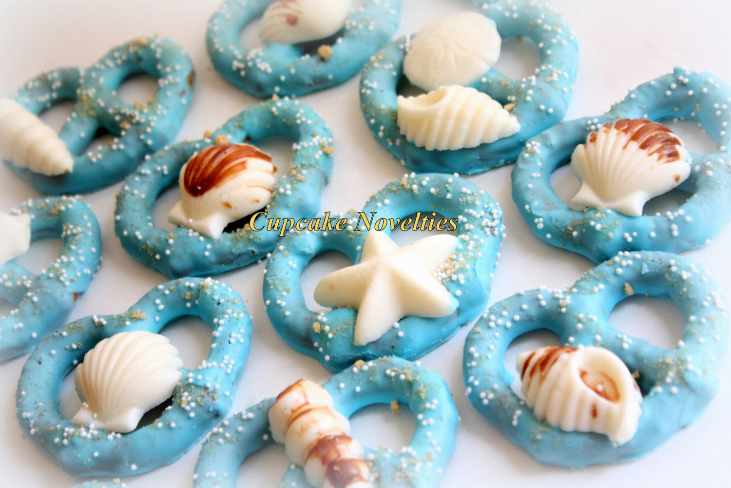 Under The Sea Blue Chocolate Covered Pretzels With White Chocolate Sea Shells. TheIcedSugarCookie.com Cupcake Novelties. Mermaid Birthday Party.