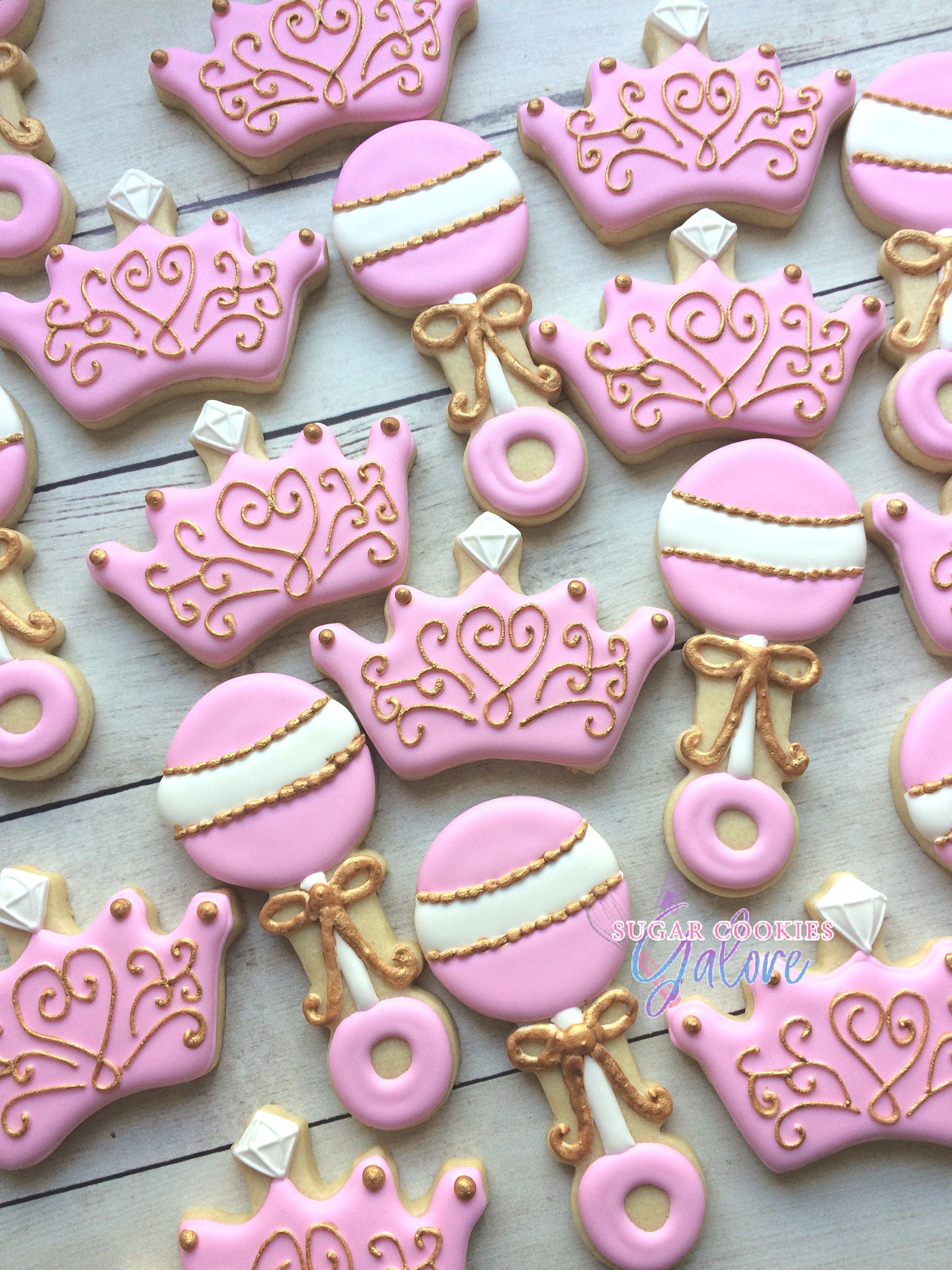 Pink And Gold Princess Baby Shower Iced Sugar Cookies by Sugar Cookies Galore Featured on TheIcedSugarCookie.com #cookies #sugarcookies #decoratedcookies #babyshowercookies #babyshower #princesscookies #babyshowerparty