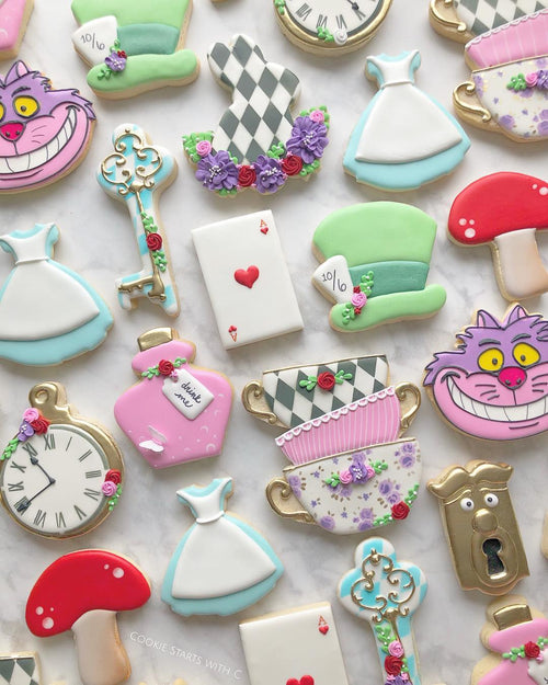 "Were All Mad Here" Alice In Wonderland Iced Sugar Cookies featured on TheIcedSugarCookie.com created by @cookiestartswithc #aliceinwonderlandcookies #aliceinwonderlandsugarcookies #aliceinwonderland #cookies #sugarcookies #decoratedcookies