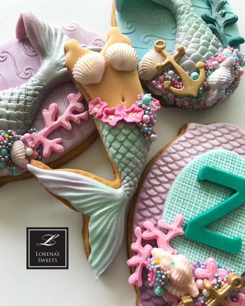 Mermaid Baby Shower Fondant Cookies by @lorenarodriguezsaenz featured on TheIcedSugarCookie.com #mermaidcookies #mermaidparty #mermaids #mermaidbirthday #mermaidbirthdayparty #theicedsugarcookie